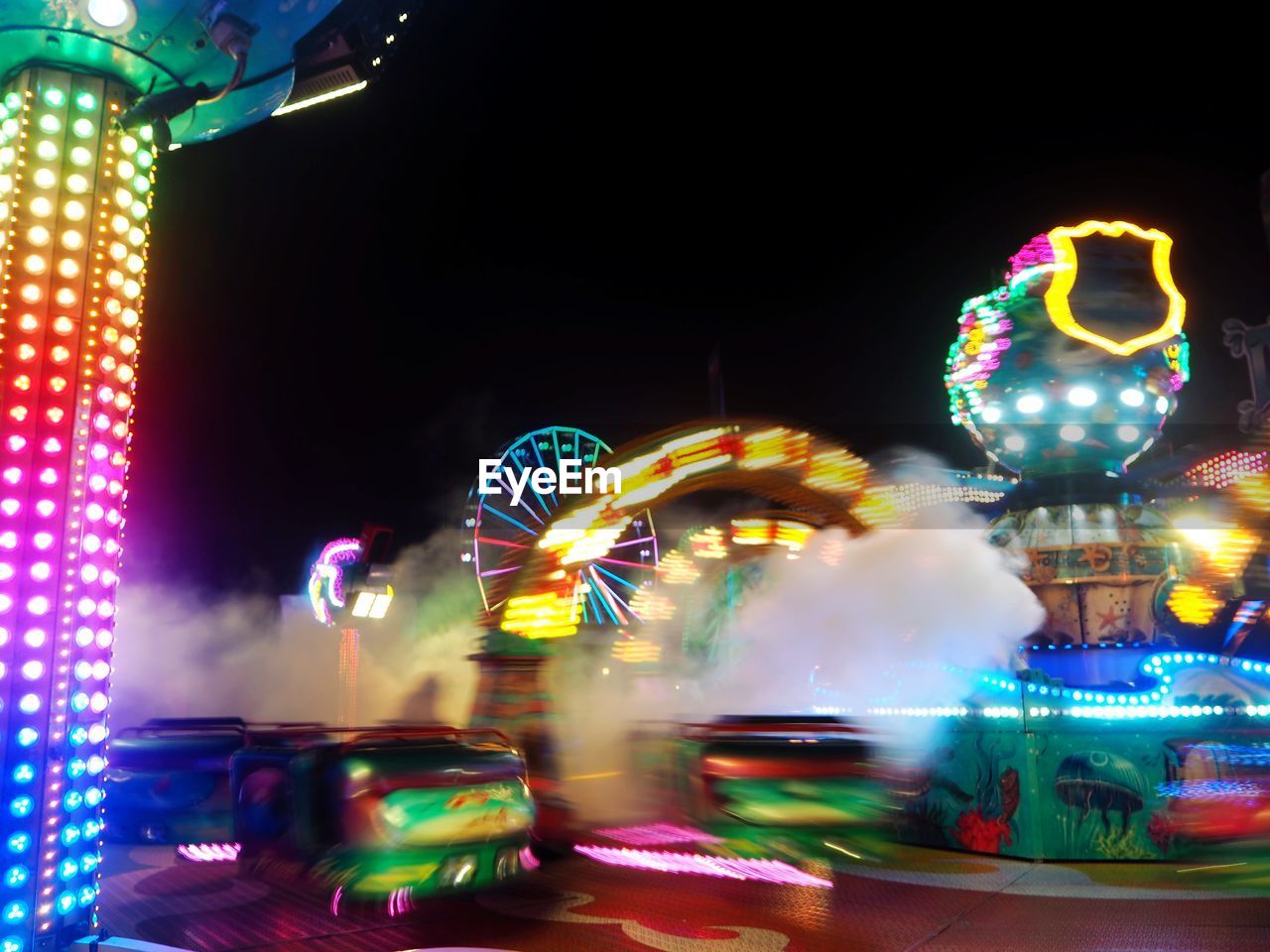 Illuminated ferris wheel at night