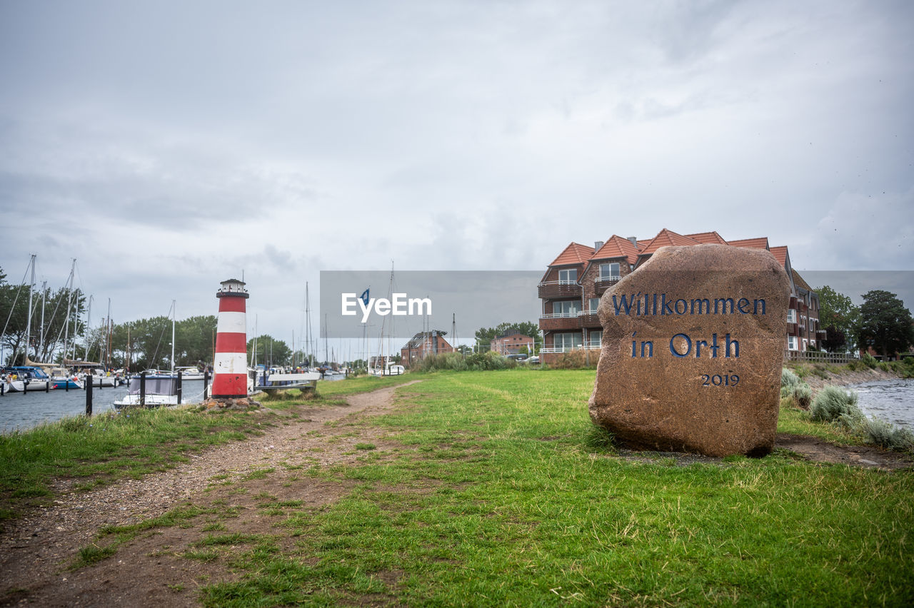 sky, cloud, grass, architecture, coast, nature, sea, rural area, land, water, built structure, no people, beach, plant, transportation, day, landscape, environment, travel destinations, building exterior, travel, outdoors, building, guidance, tree, communication