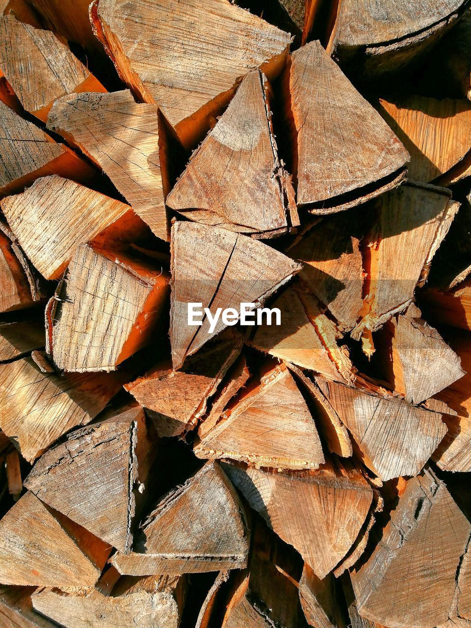 FULL FRAME SHOT OF FIREWOOD STACKED LOGS