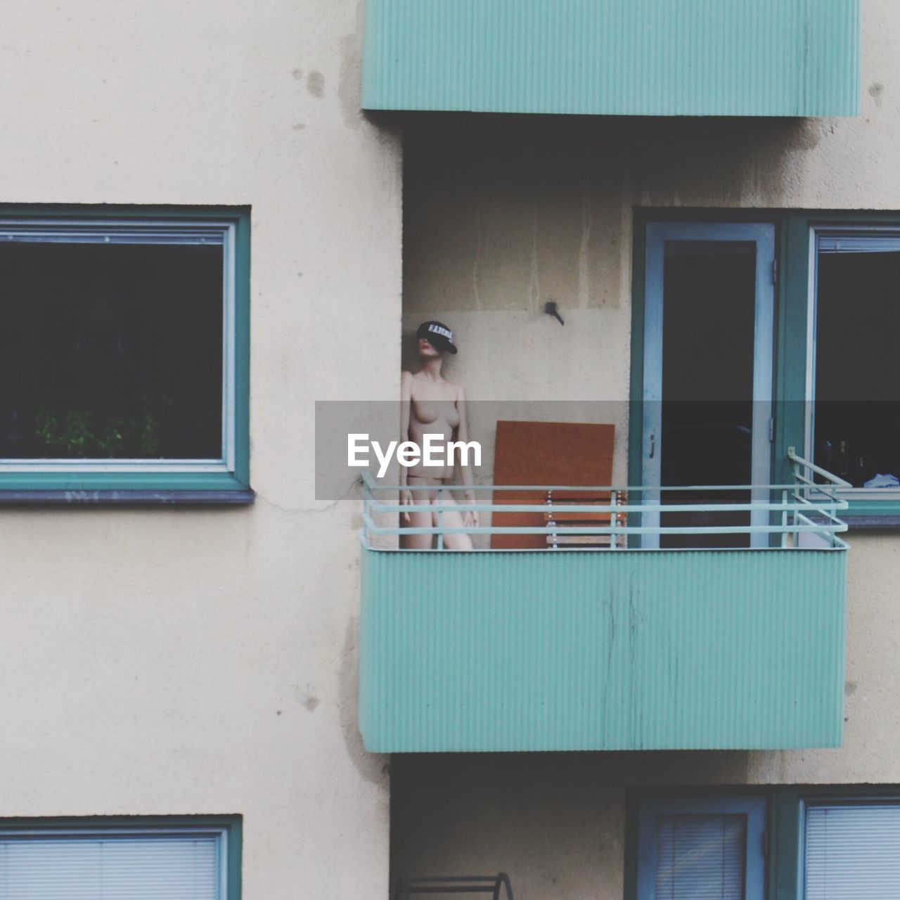 Mannequin in balcony of building