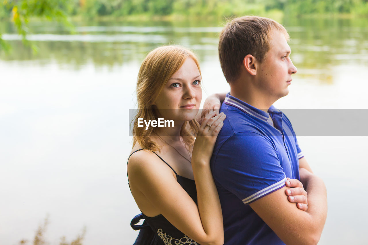 side view of young woman looking away in lake