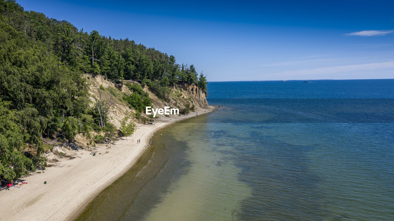 Scenic view of sea against blue sky