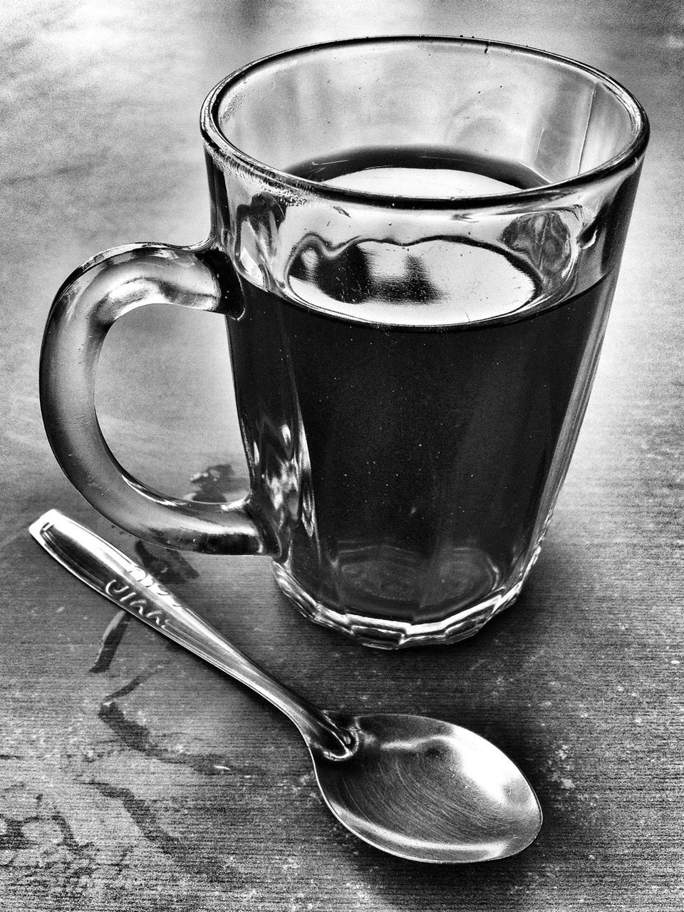 Mint tea and spoon on table