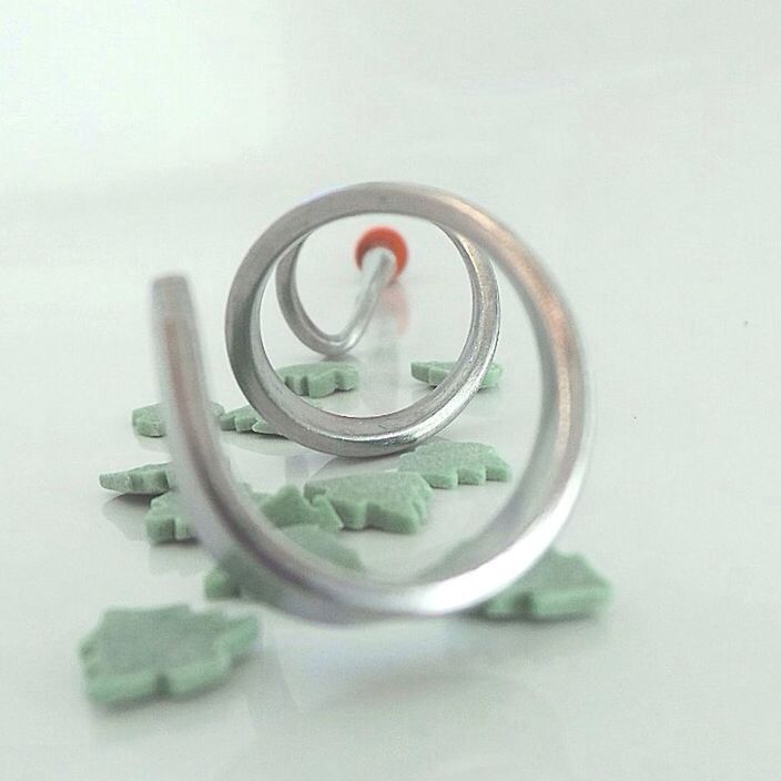 Metal tool over sweets against white background