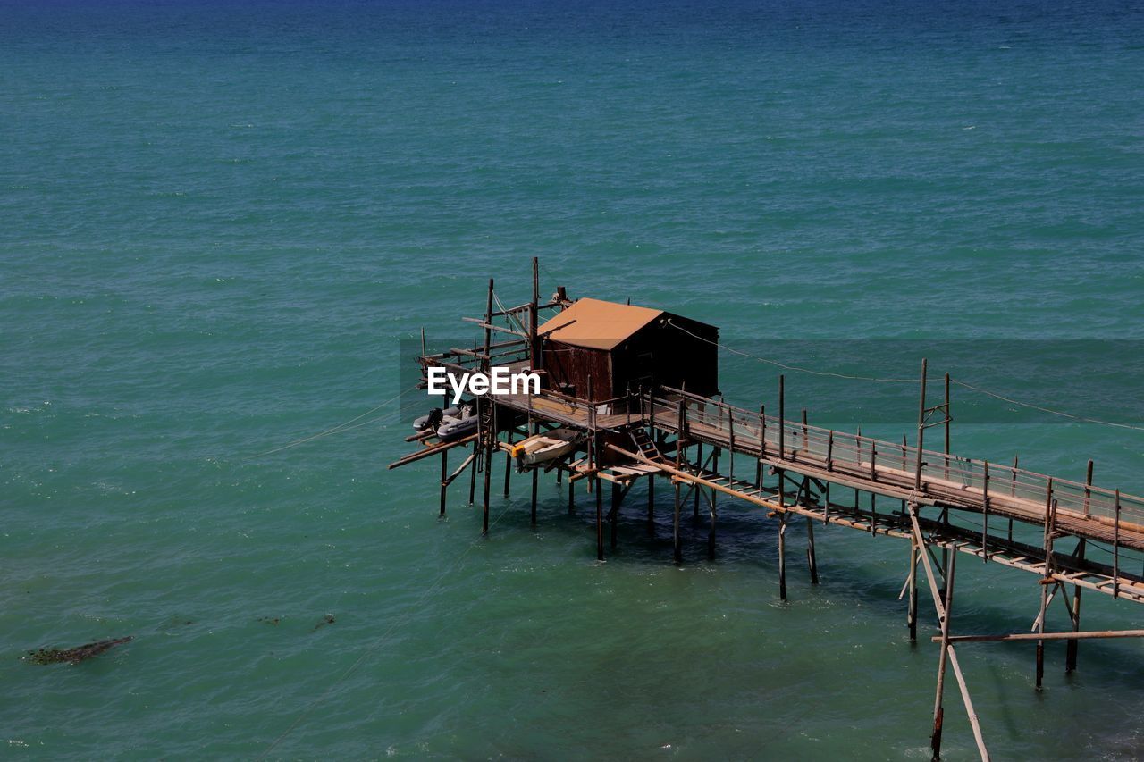 water, sea, ocean, architecture, built structure, coast, nature, no people, vehicle, bay, shore, stilt house, day, pier, building exterior, outdoors, tranquility, transportation, beauty in nature, scenics - nature, high angle view