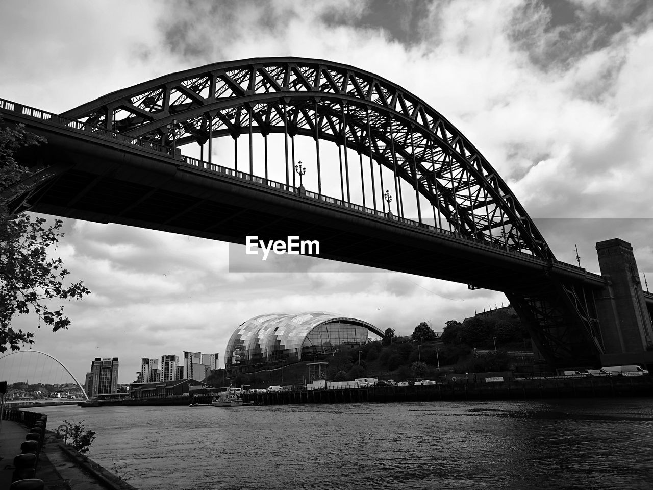 Bridge over river with city in background