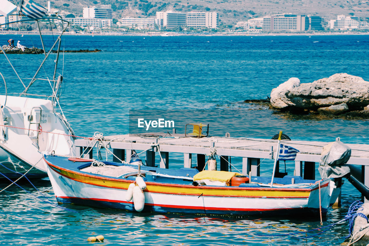 BOATS MOORED IN SEA