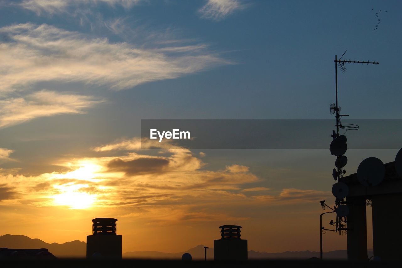 sky, architecture, sunset, built structure, cloud, building exterior, silhouette, dawn, nature, technology, building, horizon, afterglow, tower, communications tower, sun, evening, no people, city, communication, outdoors, orange color, sunlight, antenna, broadcasting, travel destinations, beauty in nature