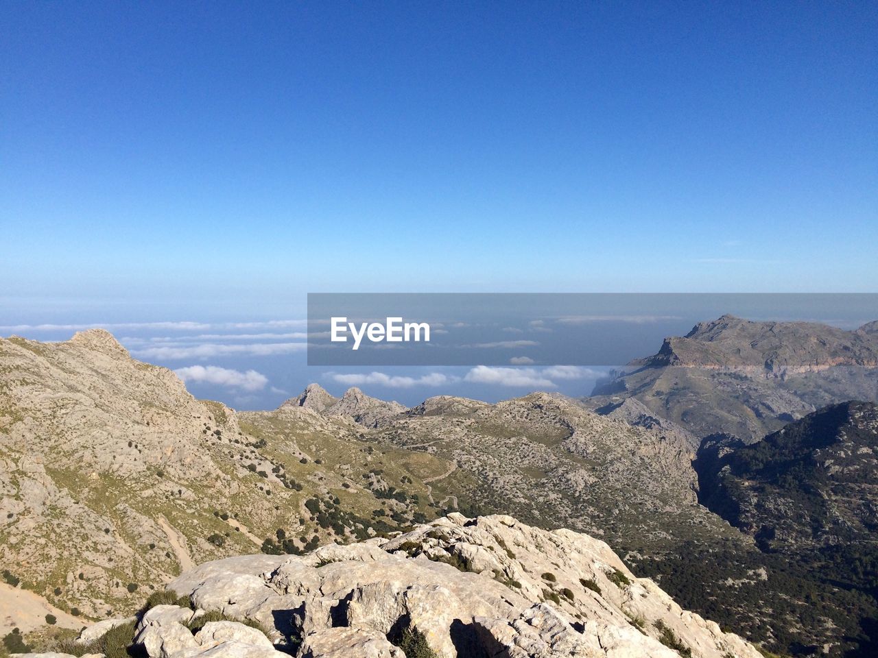 Scenic view of mountains against cloudy sky