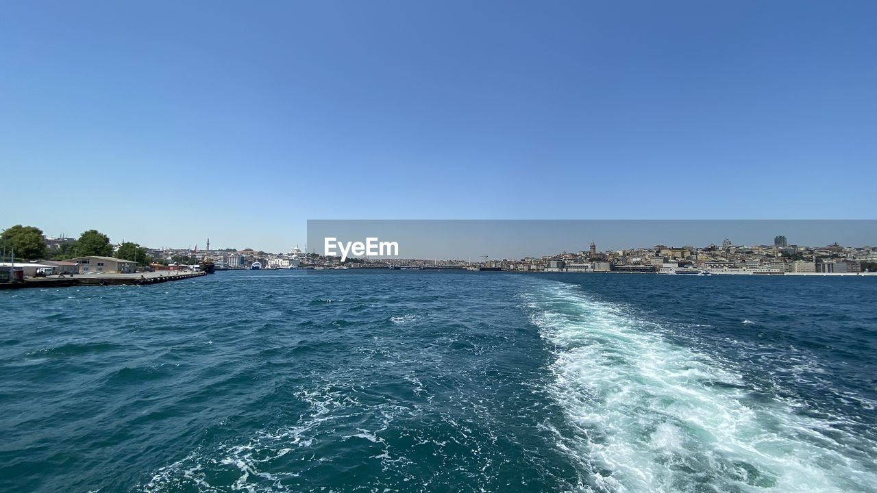 Scenic view of sea against clear blue sky