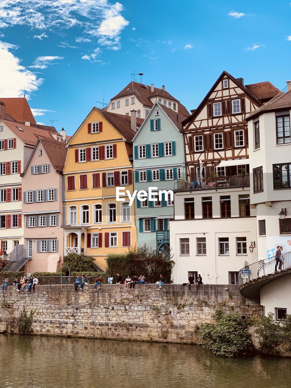 RESIDENTIAL BUILDINGS BY RIVER AGAINST SKY IN CITY