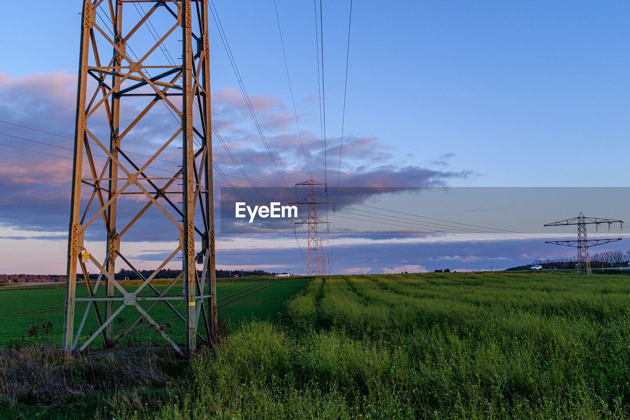 ELECTRICITY PYLON ON LAND AGAINST SKY