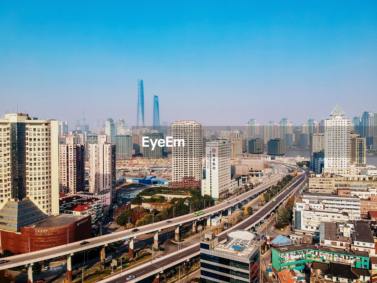 AERIAL VIEW OF CITYSCAPE AGAINST BLUE SKY