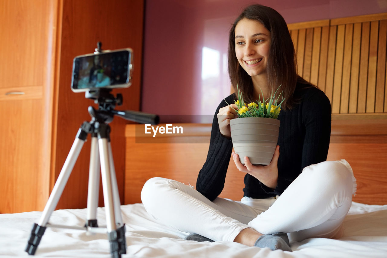 Florist and gardener recording a video with his mobile.