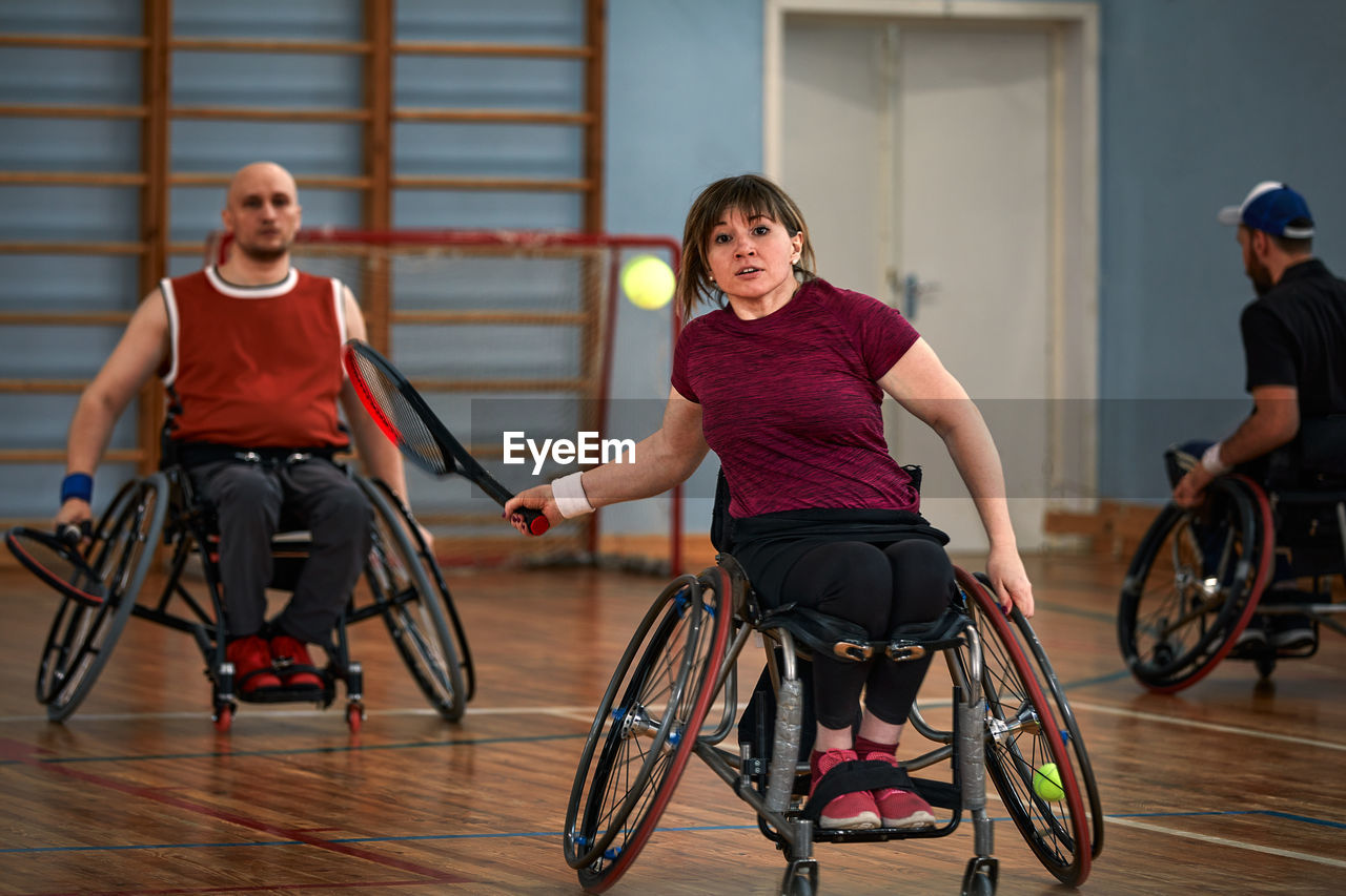 side view of woman riding bicycle on floor