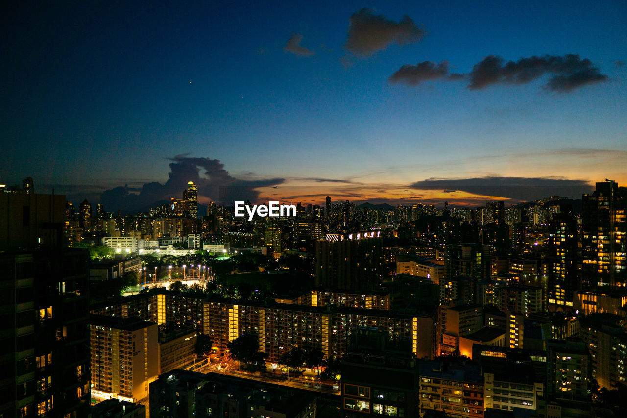 high angle view of illuminated buildings in city at night