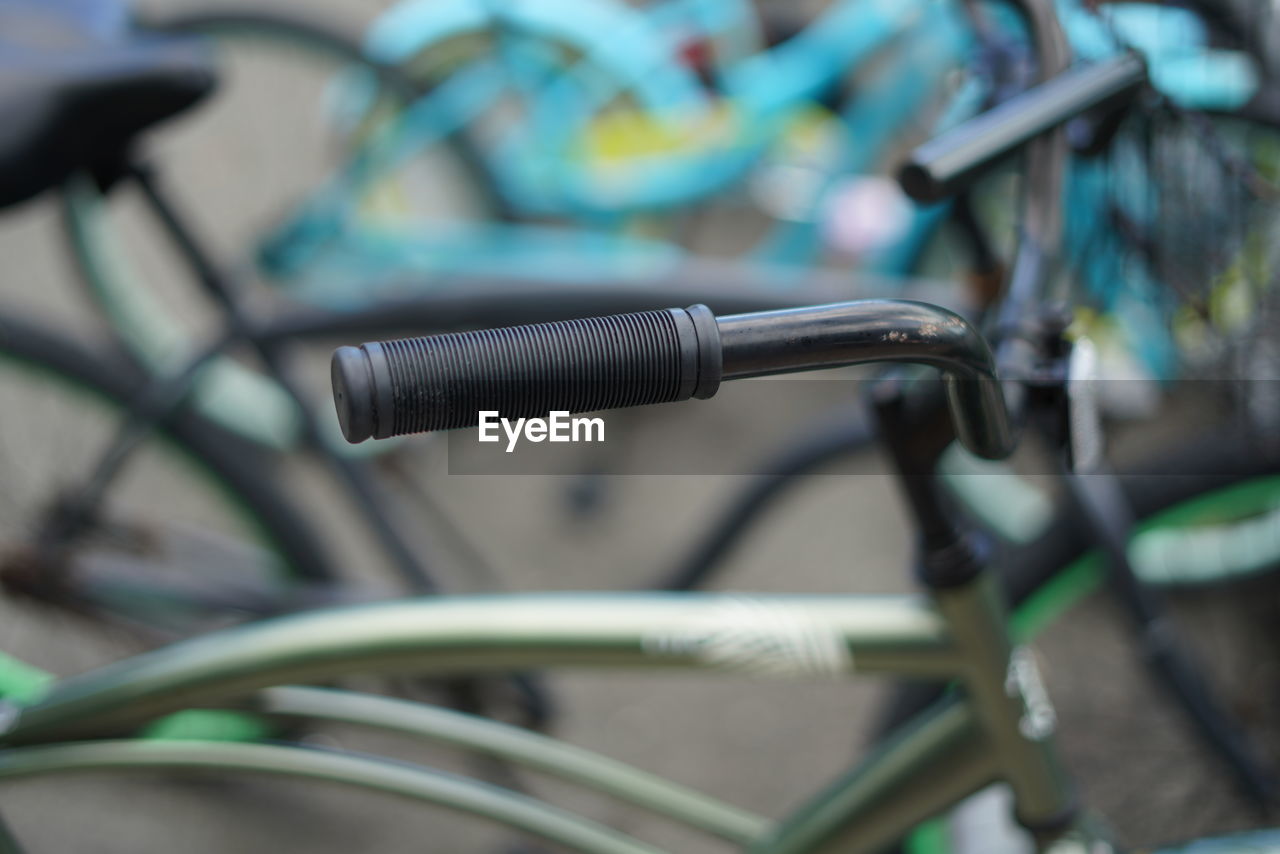 CLOSE-UP OF BICYCLE PARKED ON METAL