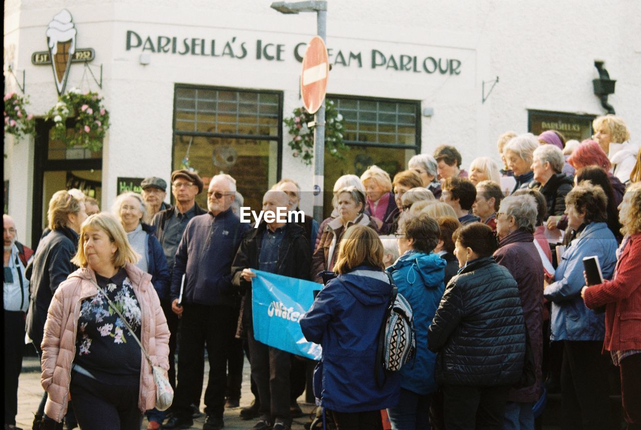 GROUP OF PEOPLE STANDING ON STREET