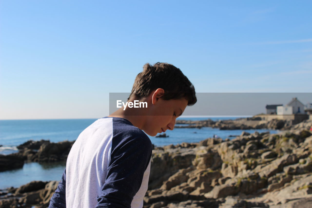 Man at beach against sky