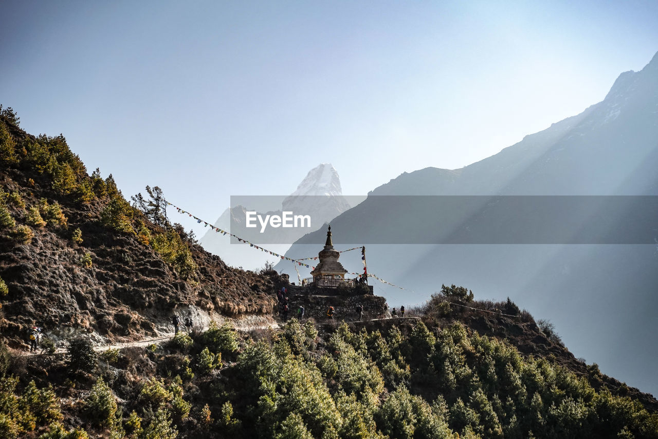 Scenic view of mountains against sky with stupa