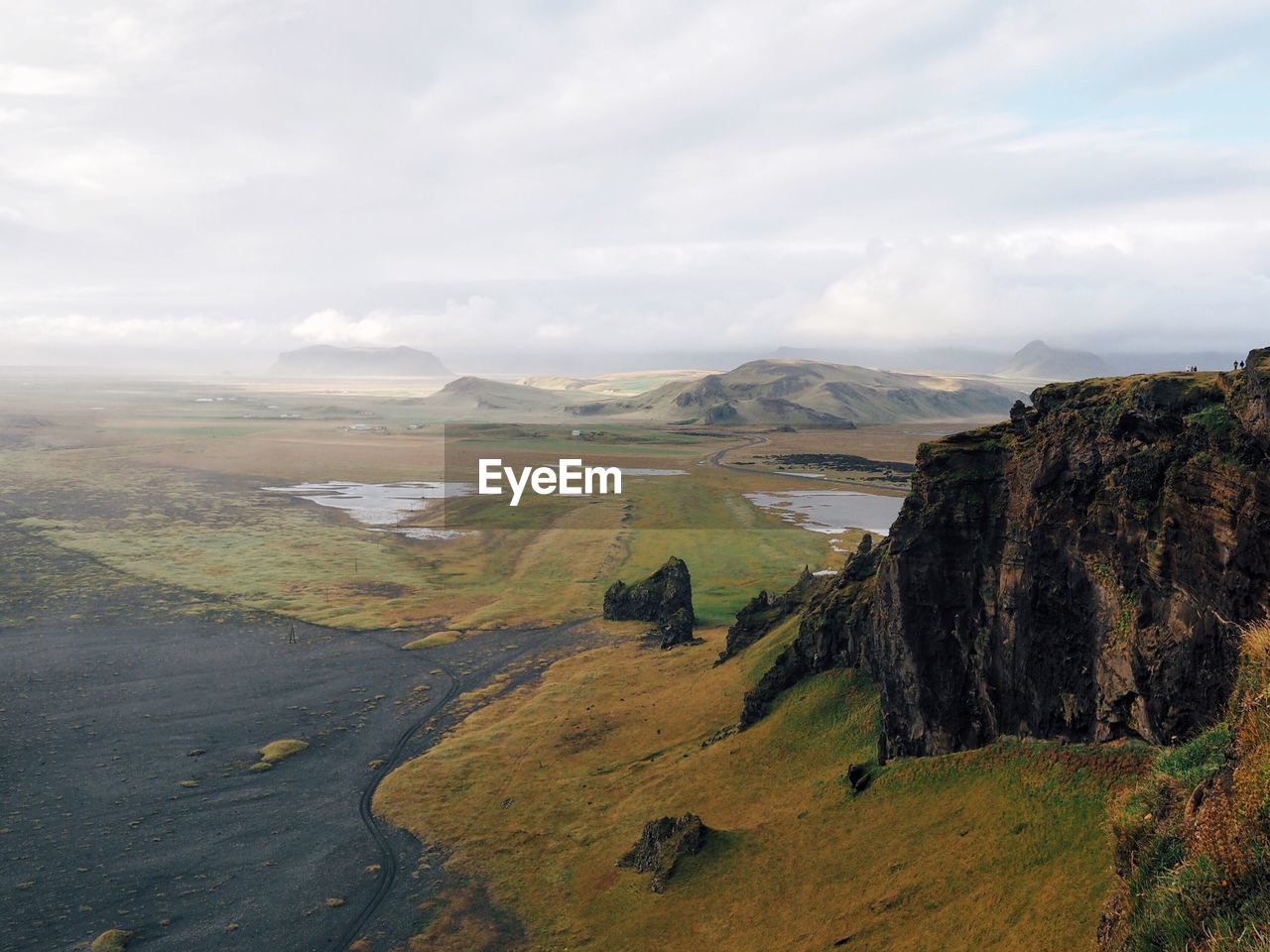 Scenic view of landscape against cloudy sky