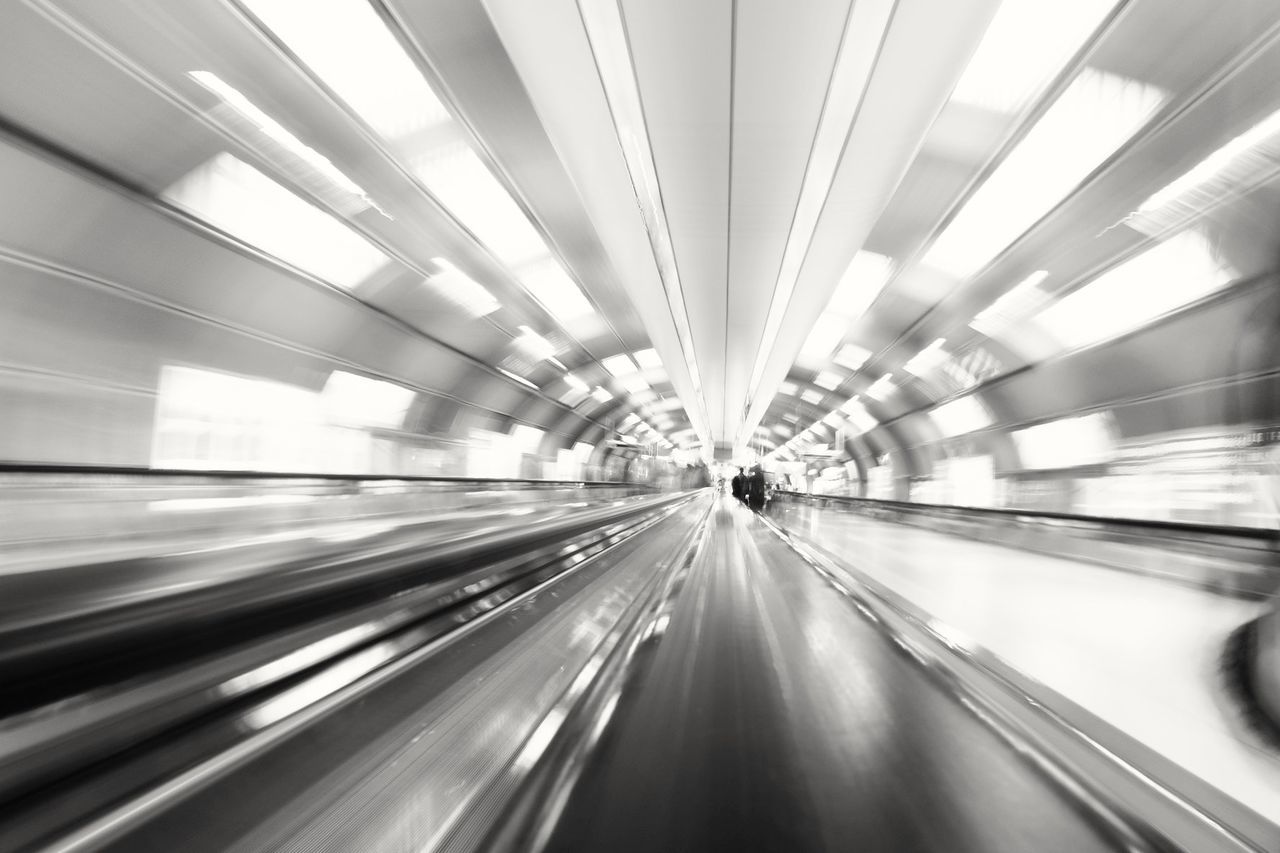 BLURRED MOTION OF ILLUMINATED RAILROAD TRACKS IN TUNNEL