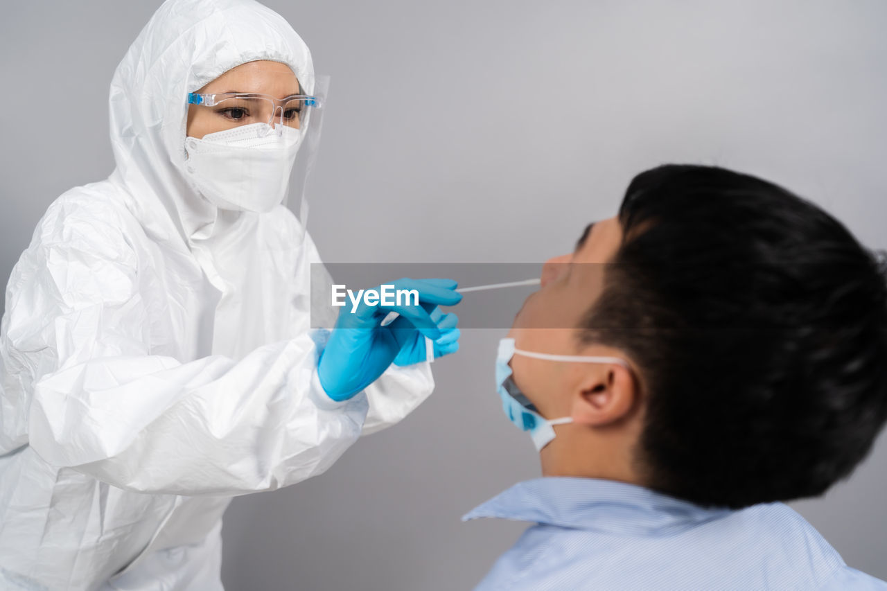 side view of female doctor examining patient in hospital