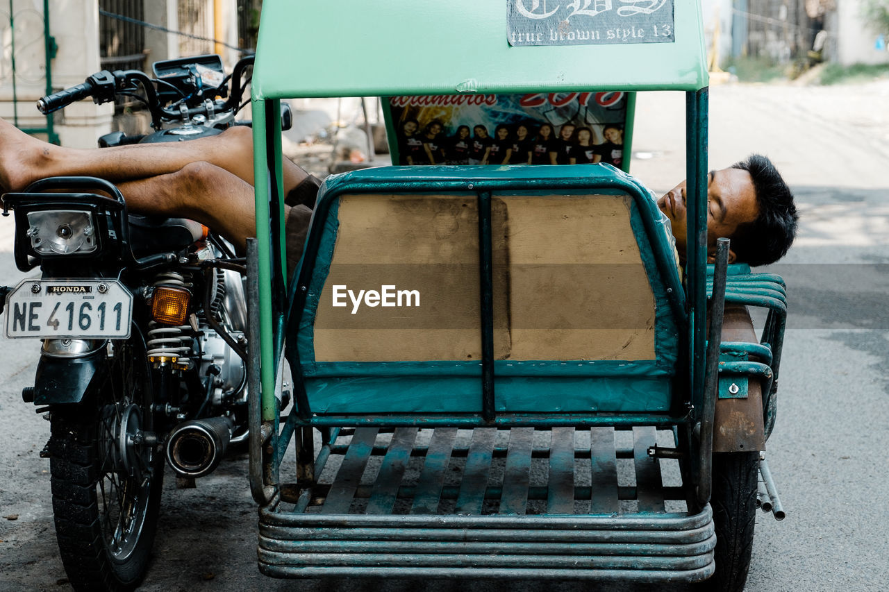 MAN STANDING ON VEHICLE