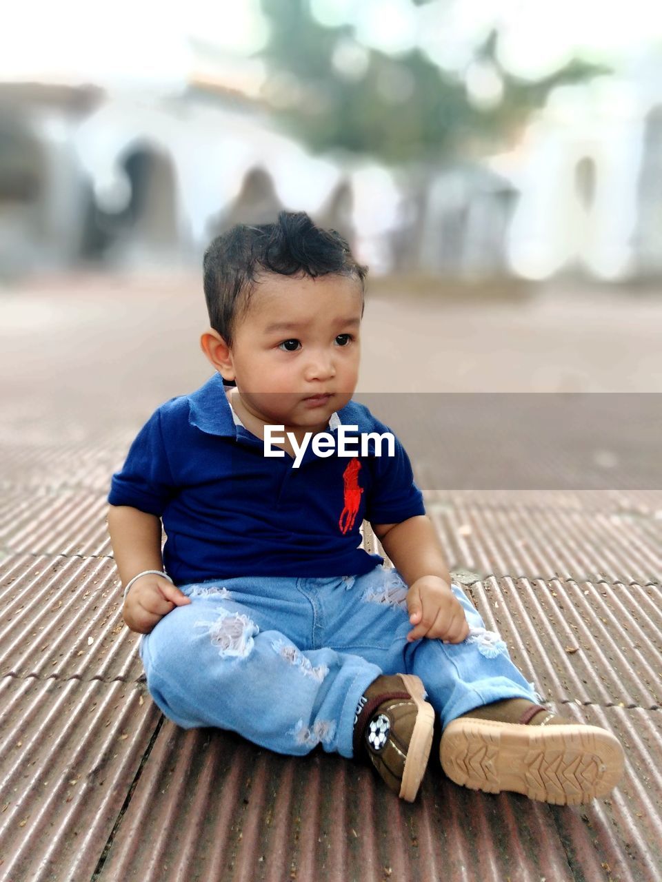 BOY SITTING ON FLOOR