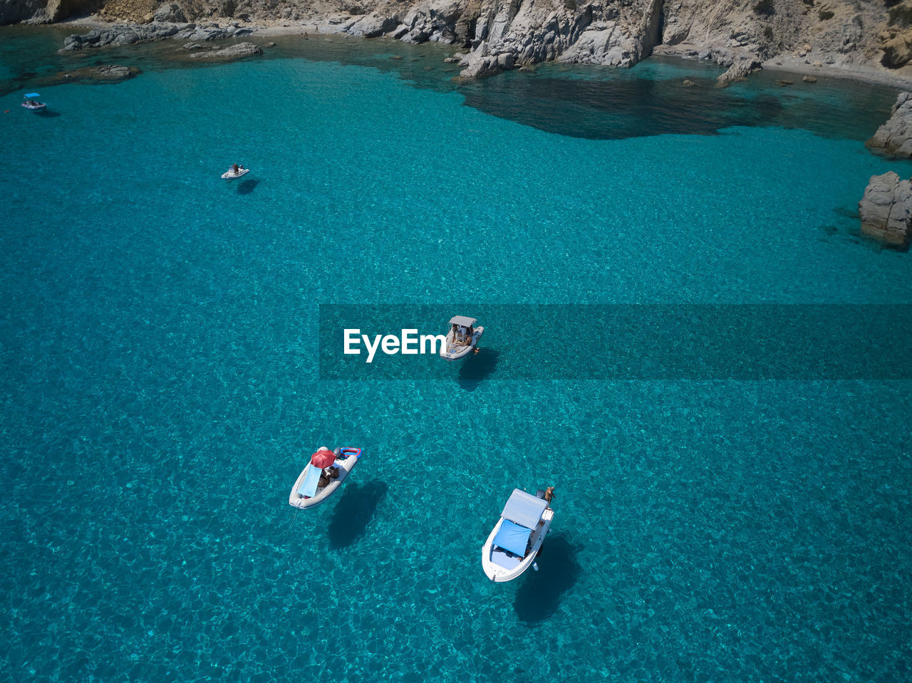 HIGH ANGLE VIEW OF ROCKS BY SEA