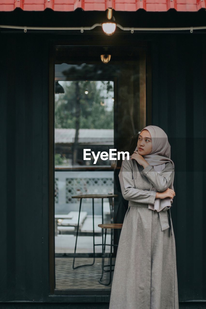 Woman standing against entrance