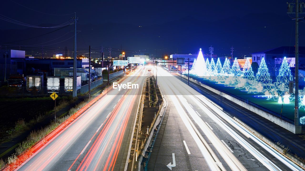 High angle view of light trails on highways during christmas