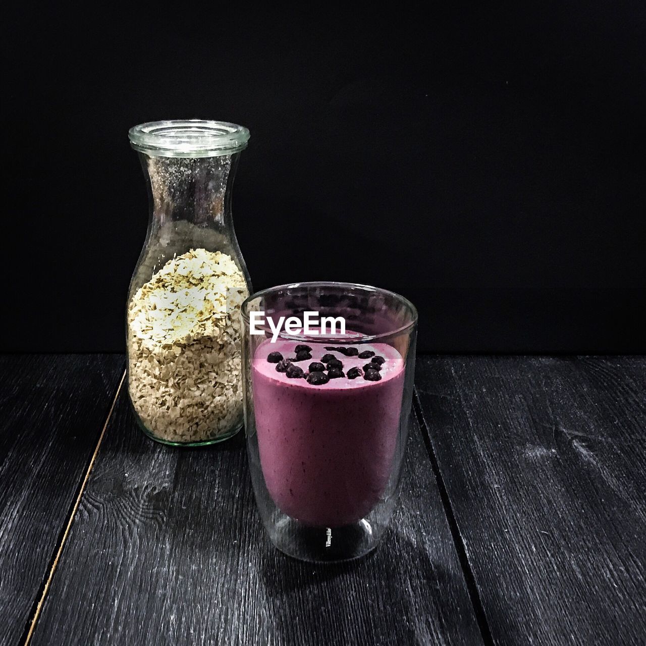 Close-up of food and drink on table against black background