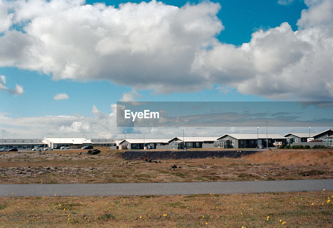 houses on field against sky