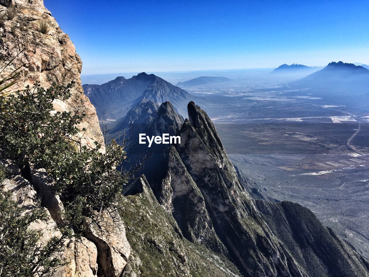 High angle shot of rocky landscape against blue sky