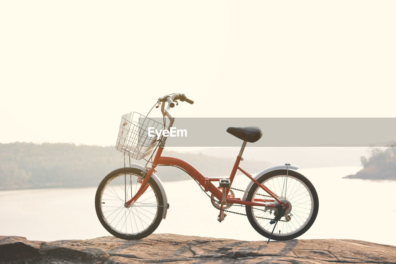 Bicycle on beach against sky