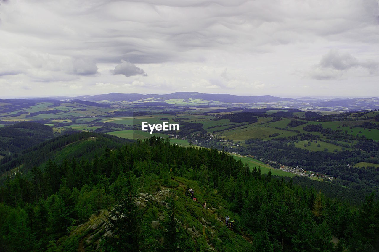 Scenic view of mountains against cloudy sky