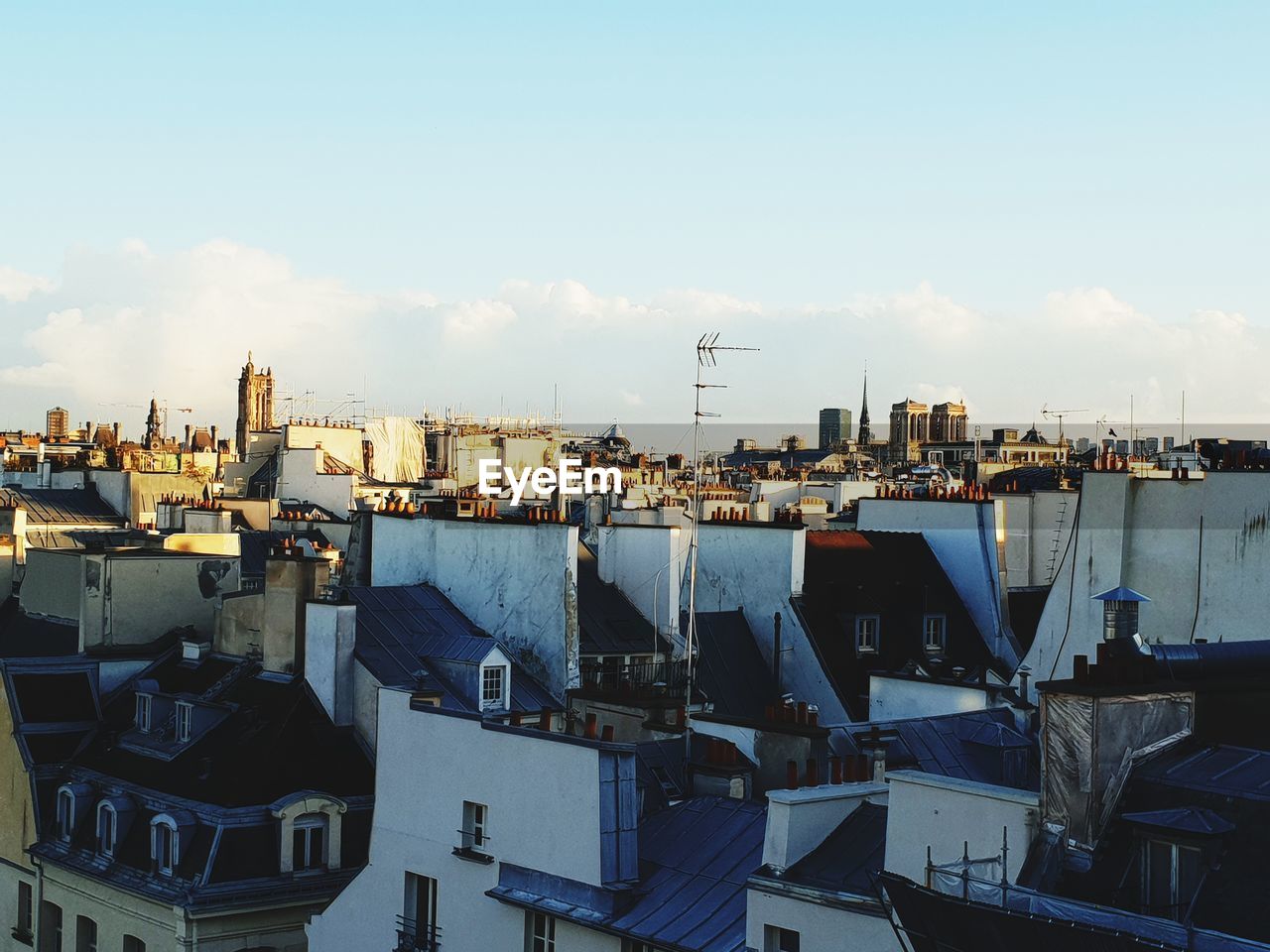 HIGH ANGLE VIEW OF BUILDINGS BY CITY AGAINST SKY