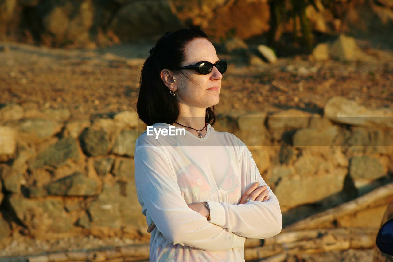 Woman wearing sunglasses while standing outdoors