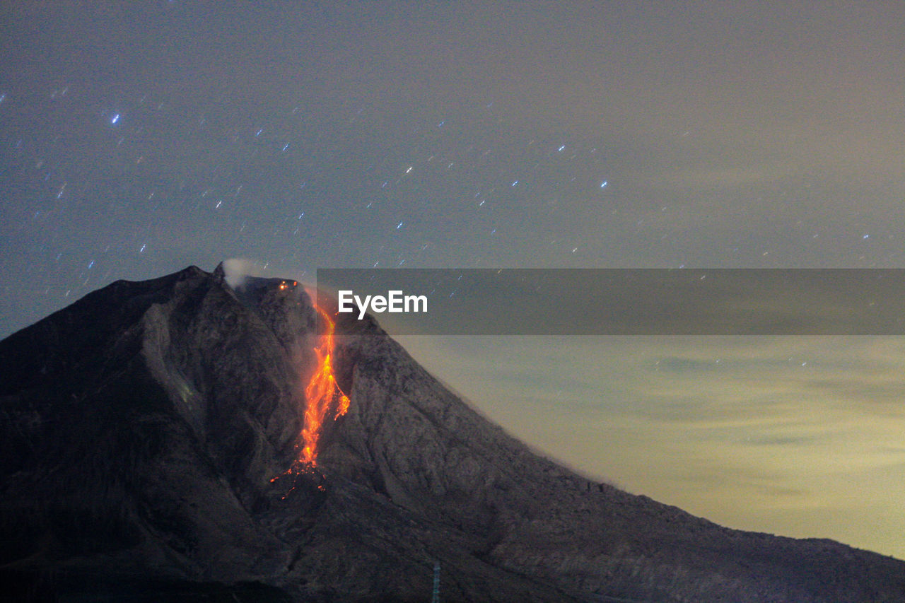 Lava running dowm sinabung volcano, seen from the village tiga pancur, karo, north sumatra