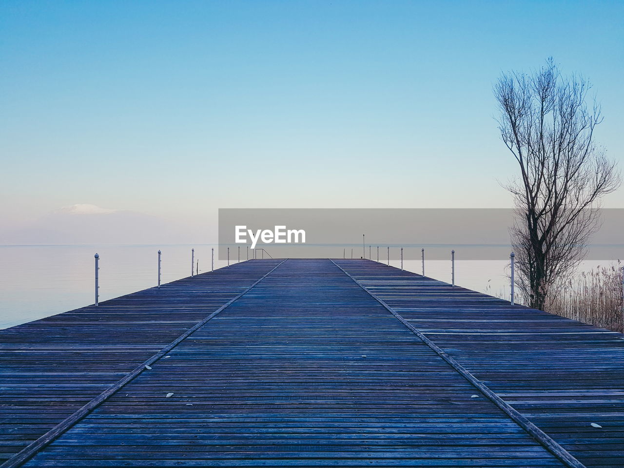 Pier over sea against clear sky