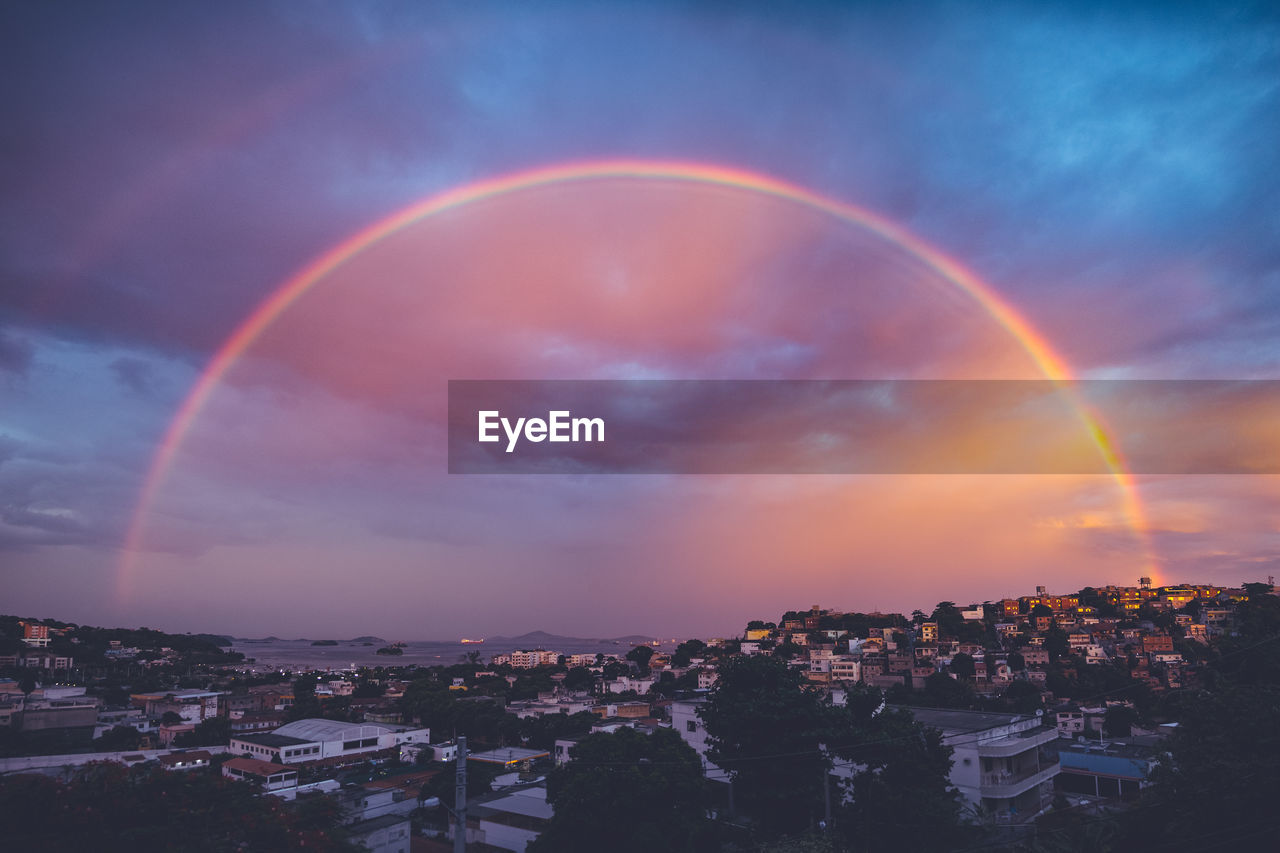 Scenic view of rainbow over city