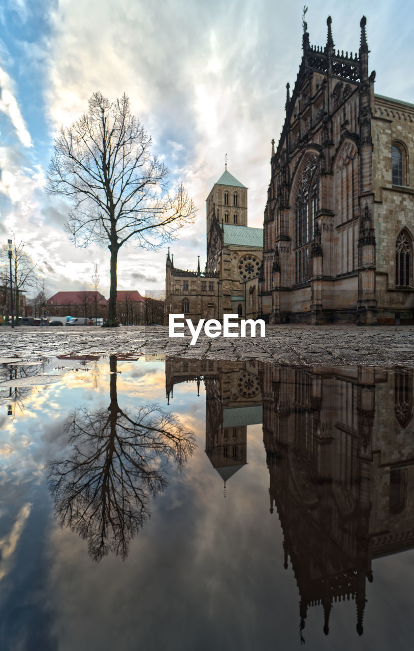 REFLECTION OF BUILDINGS IN PUDDLE