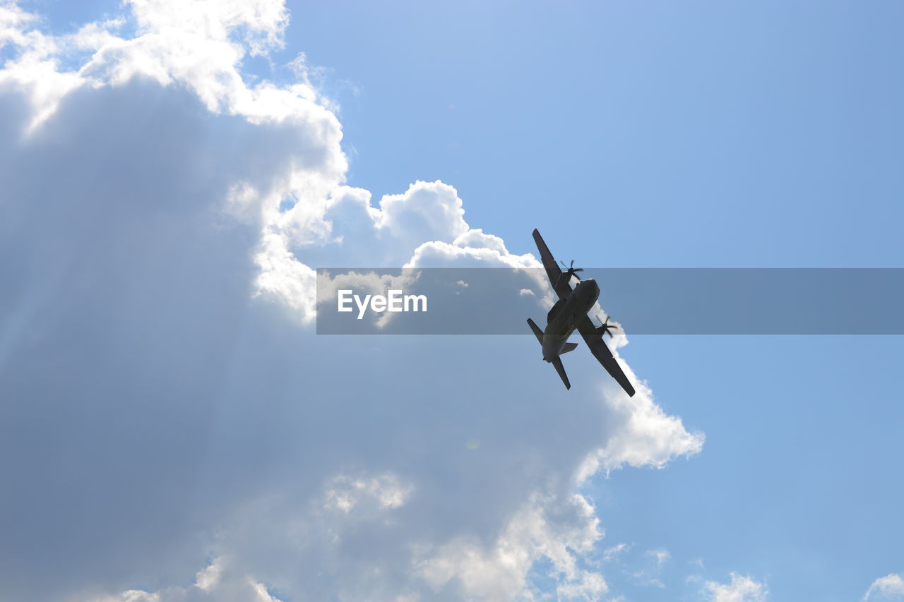 Low angle view of airplane flying against sky