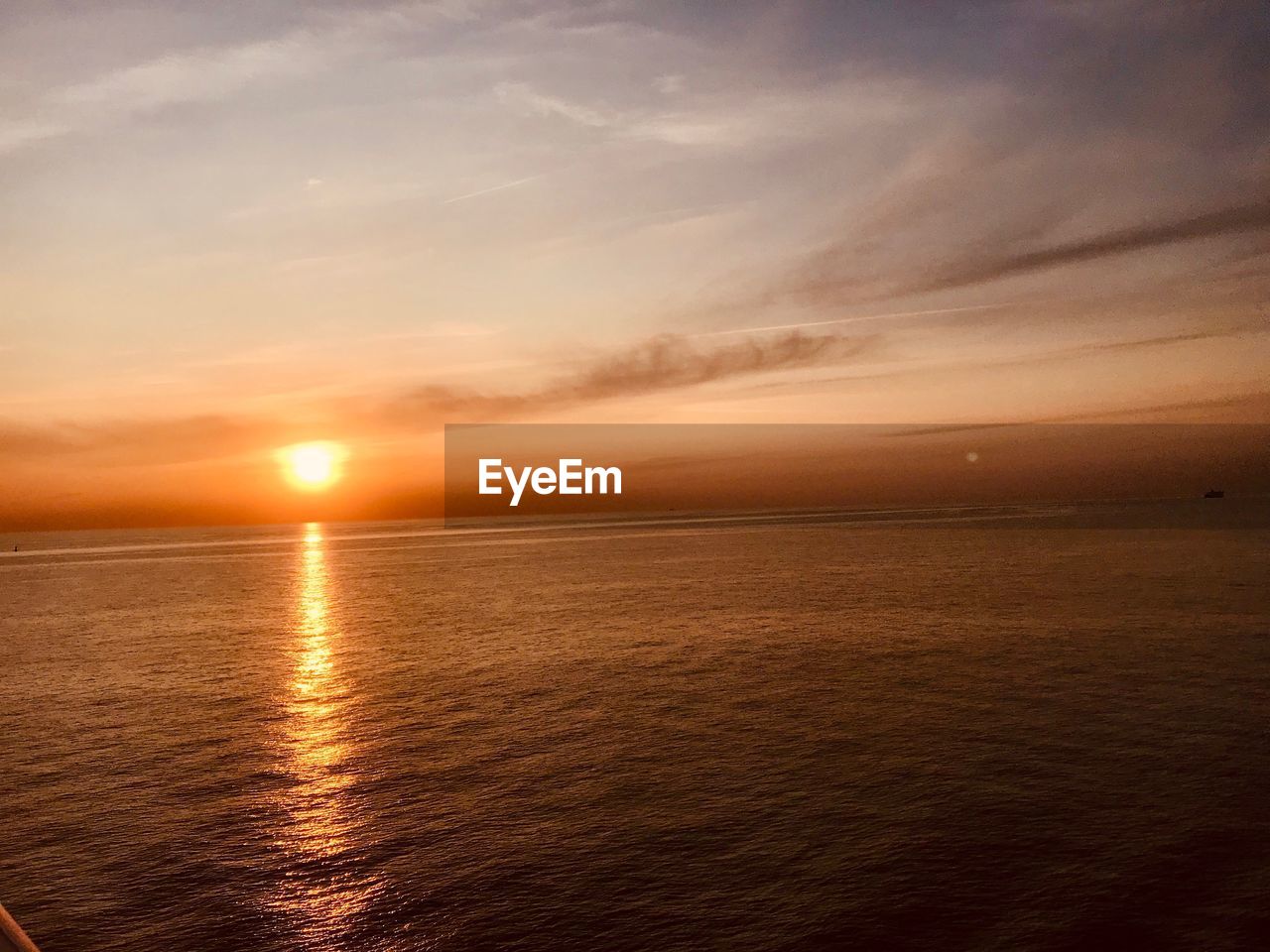 SCENIC VIEW OF SEA AGAINST ORANGE SKY DURING SUNSET