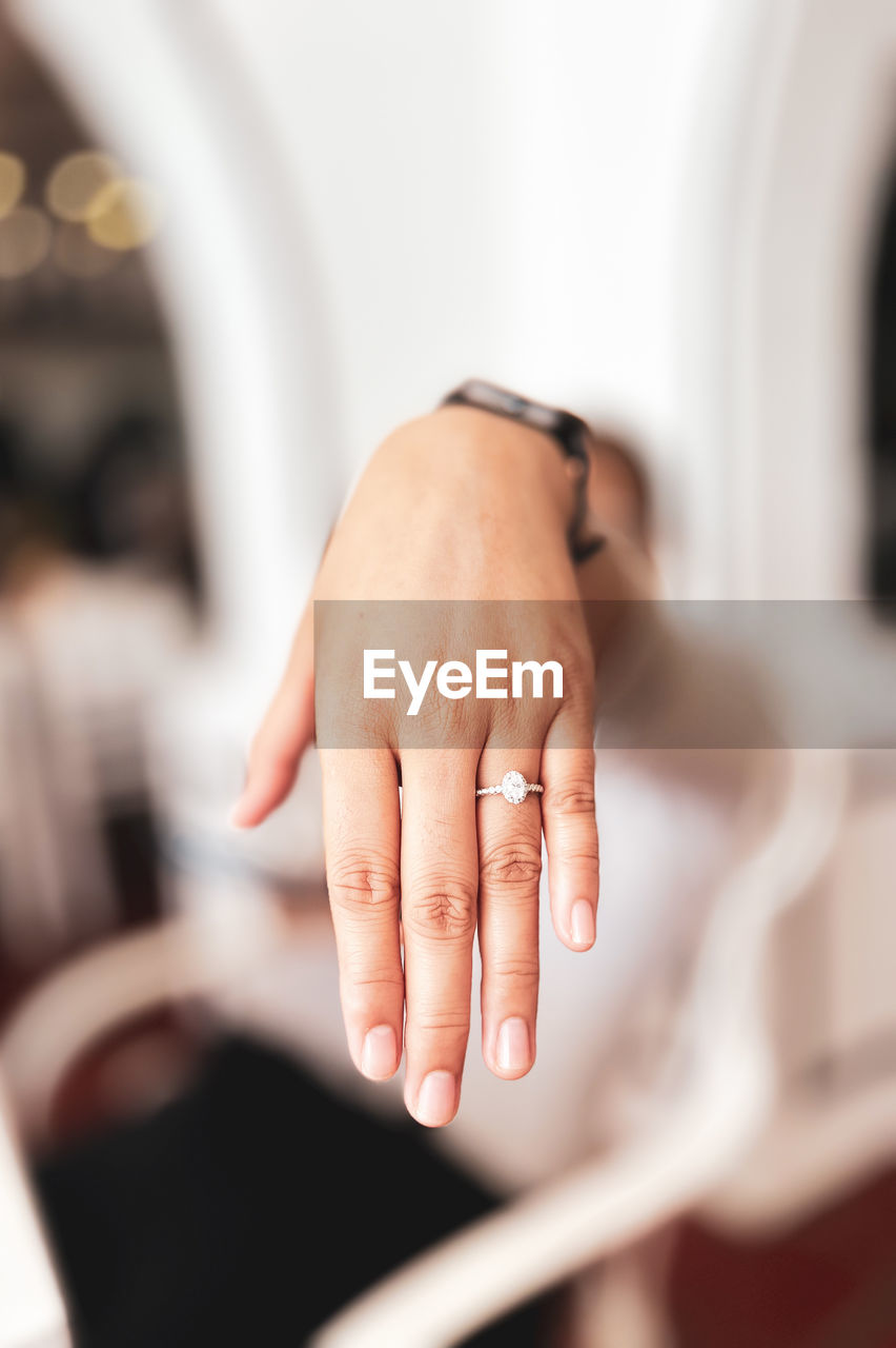 cropped hand of woman holding hands in bathroom