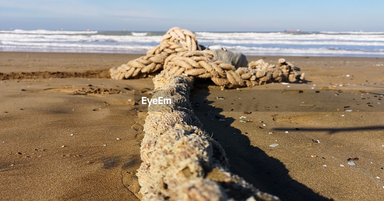 SURFACE LEVEL OF SHORE AGAINST SKY