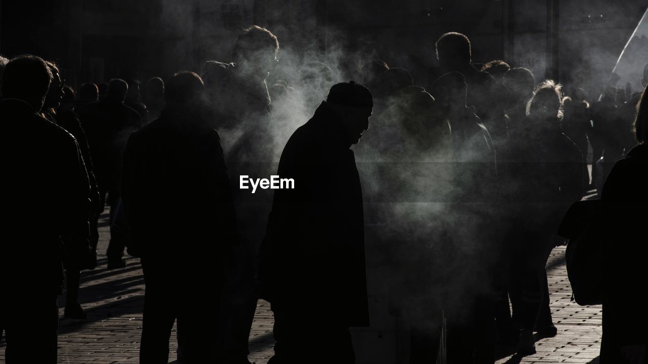 GROUP OF SILHOUETTE PEOPLE AT MUSIC FESTIVAL