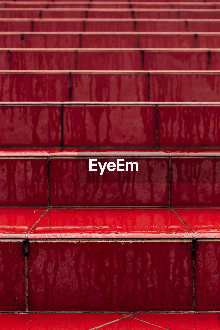 Full frame shot of red wet steps during rainy season