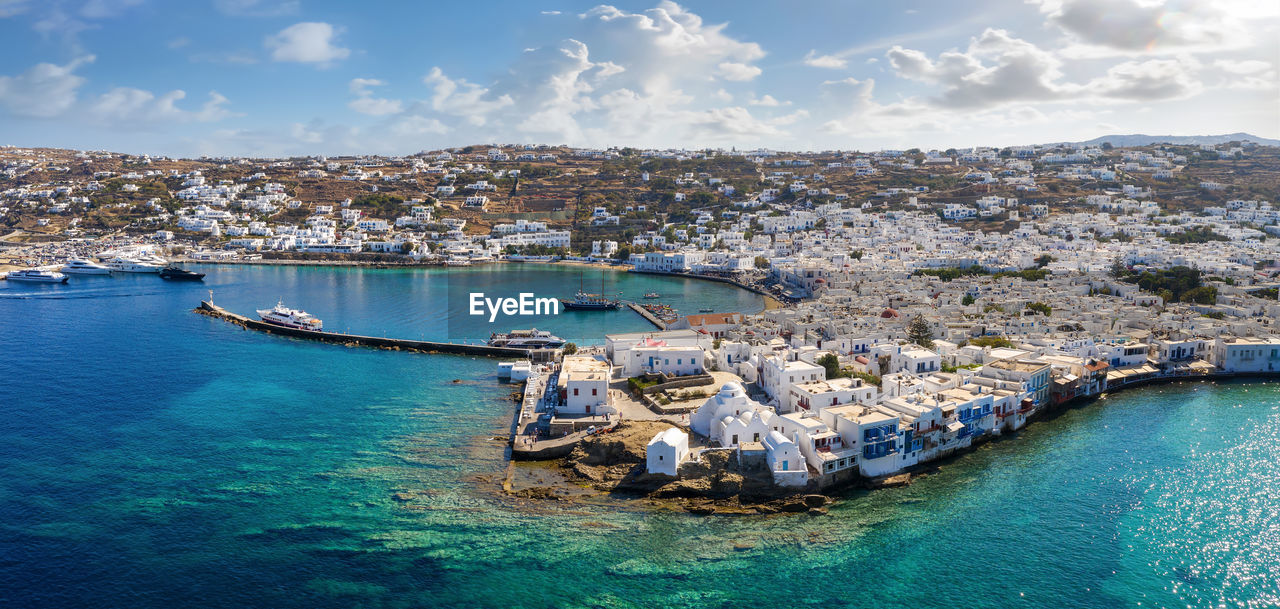 HIGH ANGLE VIEW OF SAILBOATS MOORED ON SEA AGAINST SKY